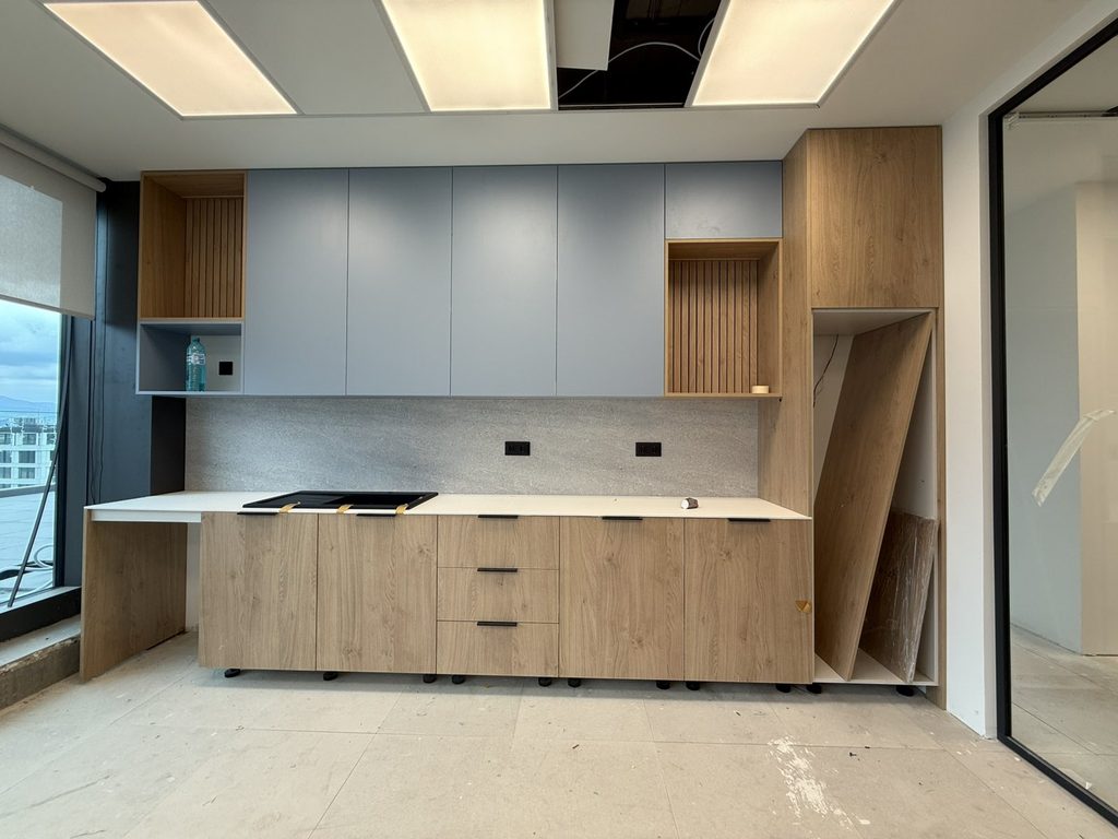 Electrical outlet aligned with bespoke office furniture in the completed interior.